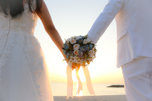 Imerovigli, Santorini, Greece - July 1, 2021: The bride and groom during a romantic photo session in Imergovigli on Santorini Island.