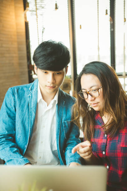 istock Business couple work with laptop together at cafe. 929904800