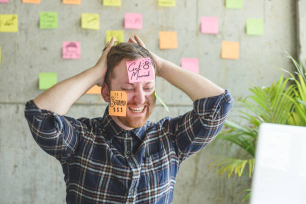 istock Stressed man with message on sticky notes over his face in office. 929910940