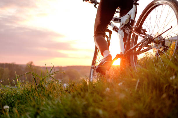 istock girl riding bilke in sunset 929911920