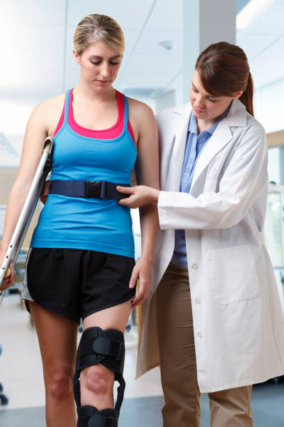 istock Physical Therapist Helping Patient With Use Of Crutches 929912326