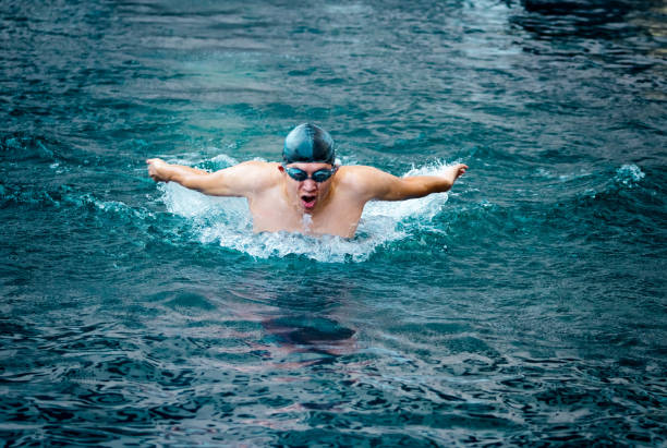 Woman wearing swimsuit swimming in water. Aquatic sport