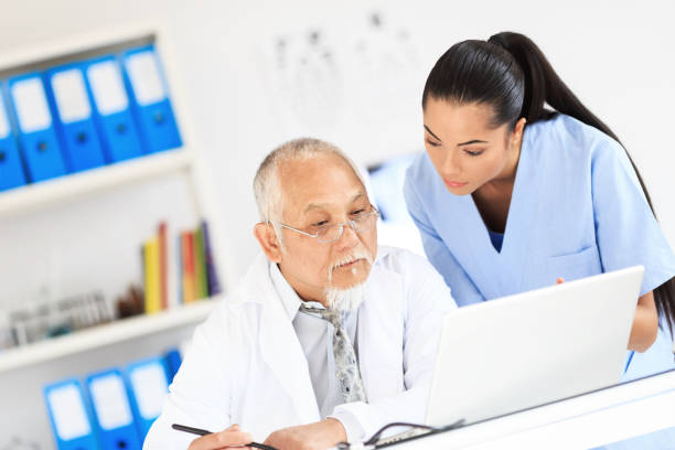 istock Nurse and doctor using laptop in cabinet 929921290