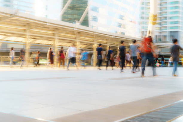 People walking in motion blur in the city People walking in motion blur in the city business architecture blue people stock pictures, royalty-free photos & images