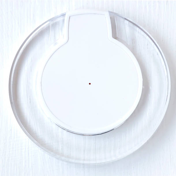 istock White wireless charger flat lay. Elements of wireless sources lie on a vintage white table. A nice mock-up for introducing innovations in the market of innovative technologies 929925374