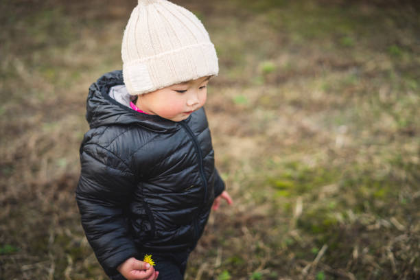 istock baby boy holding dandelion 929926538