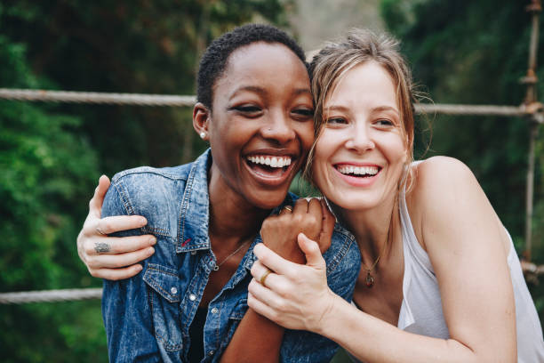 Happy women hugging each other Happy women hugging each other two people embracing stock pictures, royalty-free photos & images