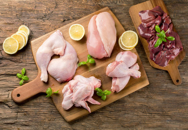 istock Raw uncooked chicken meat on wooden board. 929931540