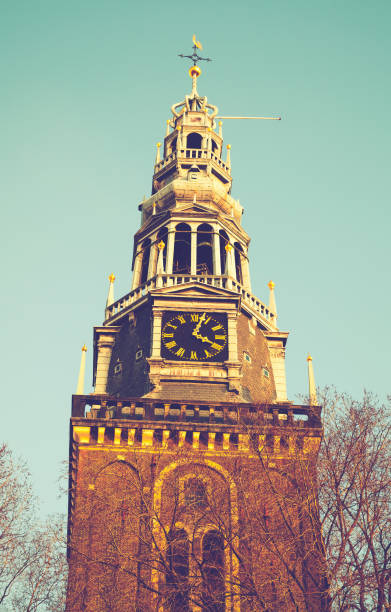 Exterior of Oude Kerk, the oldest building in Amsterdam. Vintage toned photo with retro tonal correction filter