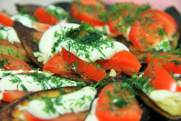 istock Fried eggplants and fresh tomato with souce and herbs 929936902