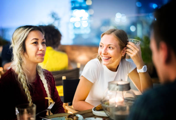 istock Friends having a dinner together at a rooftop bar 929941246