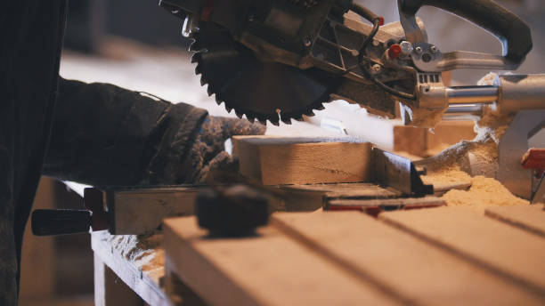 istock Worker carpenter figuring wooden board before circular saw sawing 929948898