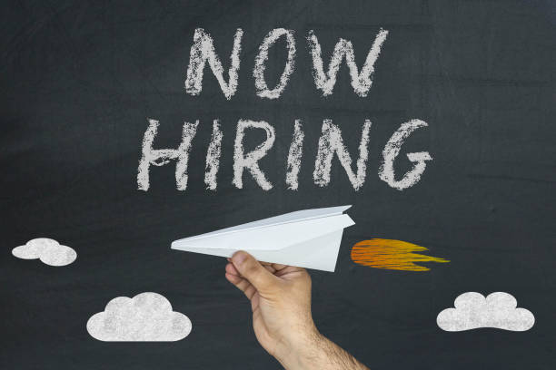 istock Paper plane and Now Hiring written on the blackboard 929949152