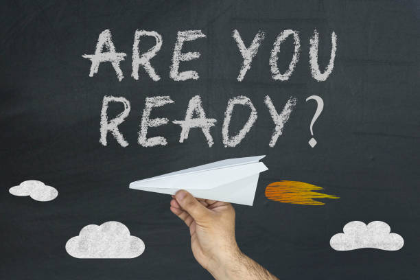 istock Are you ready text and hand with airplane on black chalkboard 929949436