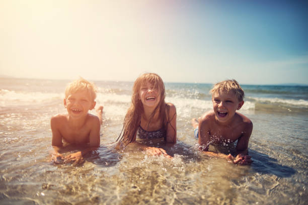 istock Kids splashing in the mediterranean sea waves 929949628