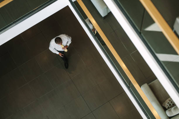 istock Businessman walking through office lobby 929953188