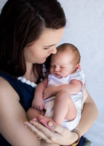 istock Mother holding sleeping newborn baby 929956174