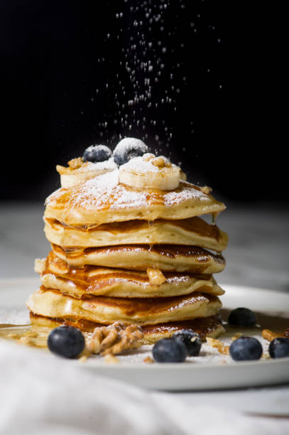 istock Pancake pile with blueberry sifting powdered sugar on the top of it. 929960310