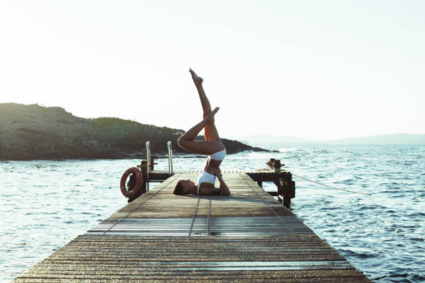 istock Sportswoman practicing yoga at the seaside 929967634