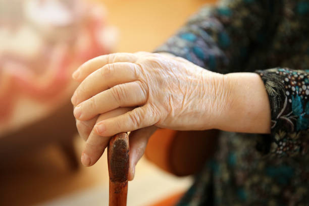 istock Old woman with cane 929968850