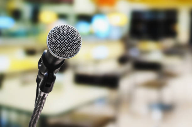 istock microphone in conference room with blur light background 929982024