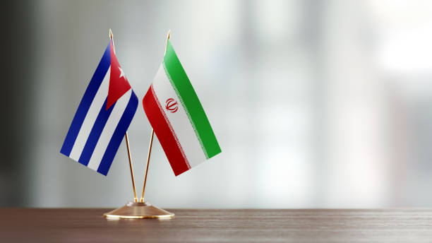 istock Cuban And Iranian Flag Pair On A Desk Over Defocused Background 929989636
