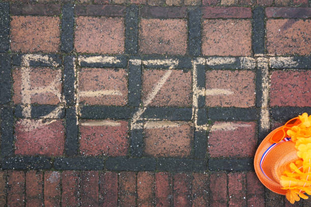 Occupied written in Dutch on the steet for Dutch kingsday with a orange head