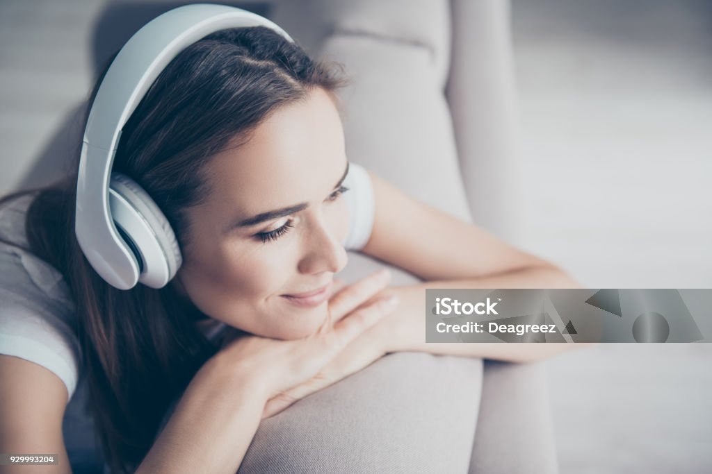 Chillout, satisfaction, therapy, wellness, leisure, lifestyle mode. Charmed adorable brown haired adorable model enjoying to the stereo sound in big modern ear phones in a room, nice break, good-day Headphones Stock Photo