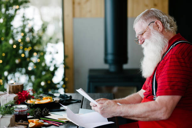 istock Santa Claus smiling while reading children's letters 929997164