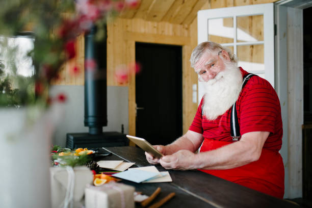 istock Tech savvy Santa Claus at his home 929997284