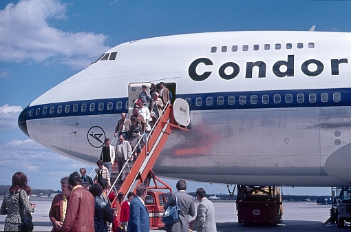 Mexico City, Mexico, 1974. After landing, passengers leave a Boeing 474 over the gangway to the outside.