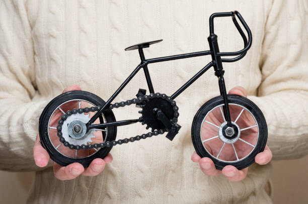 istock Antique miniature bicycle in the hands 930007520