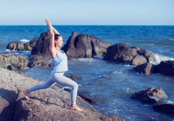 istock woman doing yoga on the beach 930011408