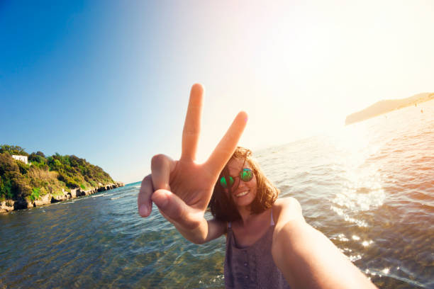 istock Happy woman in summer vacation taking selfie 930022618