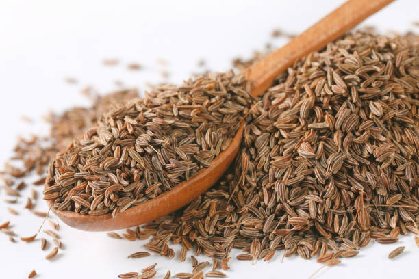 istock pile and spoon of caraway seeds 930023168