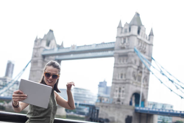 istock Young woman taking selfie in front of Tower bridge 930025746