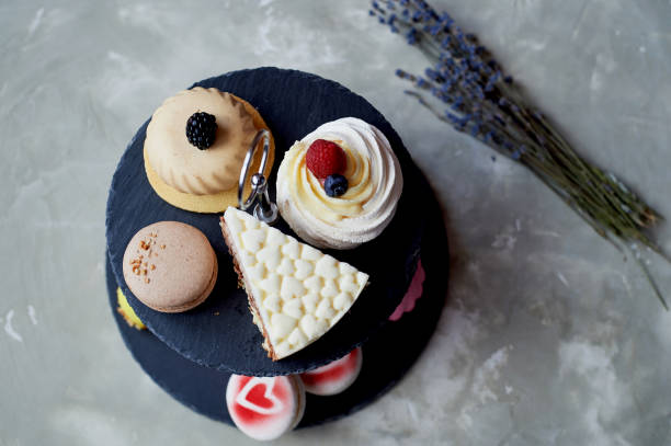 istock Cakes on a dark slate bunk stand.Desserts. Sweet table 930026260