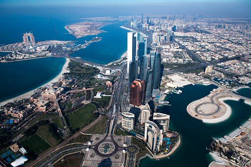 Helicopter point of view of Abu Dhabi skyscrapers and famous Emirates Palace Hotel.