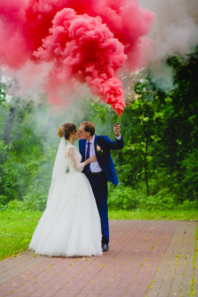 istock Bride and groom with the red colored smoke 930027742
