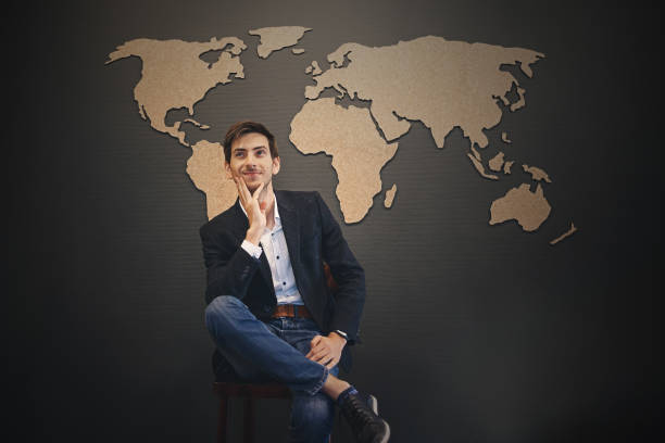 istock Young man looking to world map with crossed hands 930030604