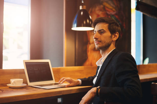istock Portrait young confident businessman sitting near window 930030930