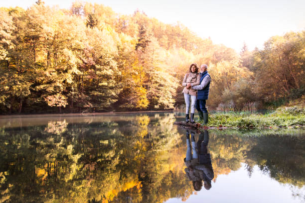 istock Senior couple on a walk in autumn nature. 930031184