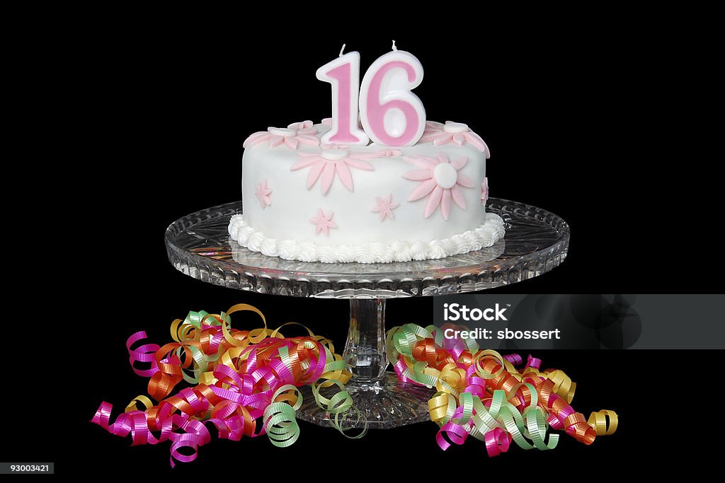 Sweet Sixteen Cake A "Sweet Sixteen" birthday cake decorated with pink and white fondant daisies. Candle Stock Photo