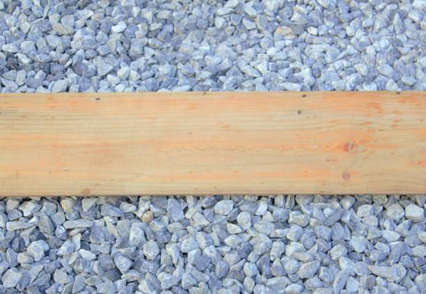 istock Brown wooden board on a rocky background. 930034460
