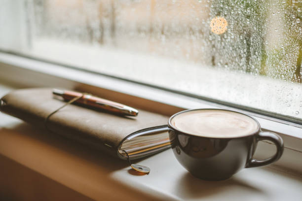 istock Coffee on a window sill in a rainy day. 930038110