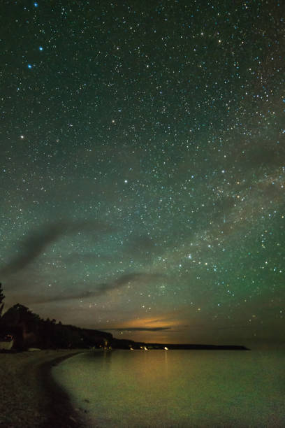 istock Colorful night sky with milky way, stars reflecting on a lake 930039292