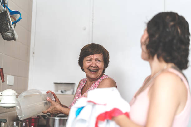 istock Daughter helping her mother washing dish in kitchen 930041730
