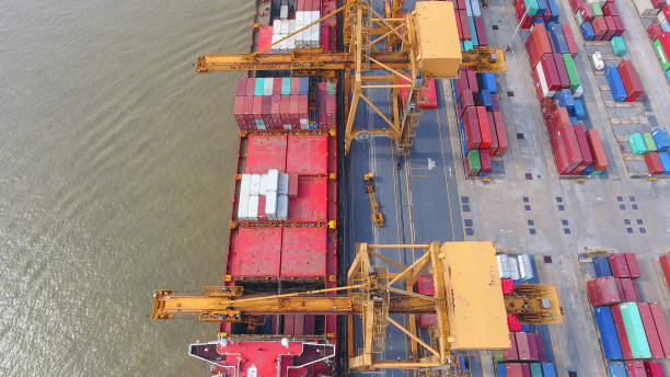 istock Logistics and transportation of Container Cargo ship and Cargo working crane bridge in shipyard 930043534