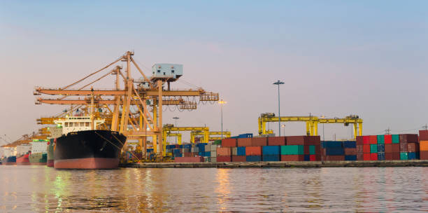 istock Logistics and transportation of Container Cargo ship and Cargo working crane bridge in shipyard 930047738