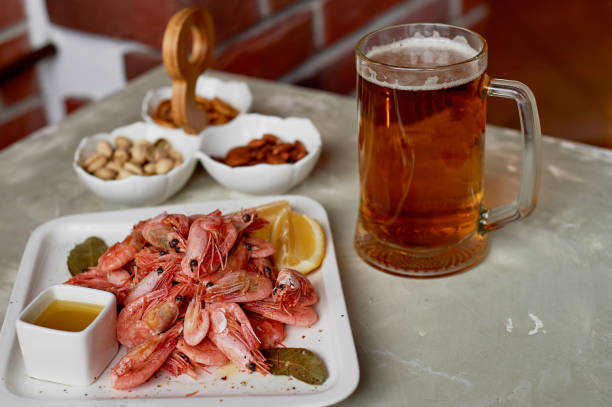 Beer snack in the pub or bar. Beer, shrimps and nuts.